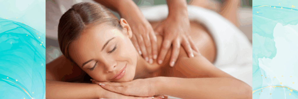 A woman lays on a massage table. She is smiling as she receives a massage.